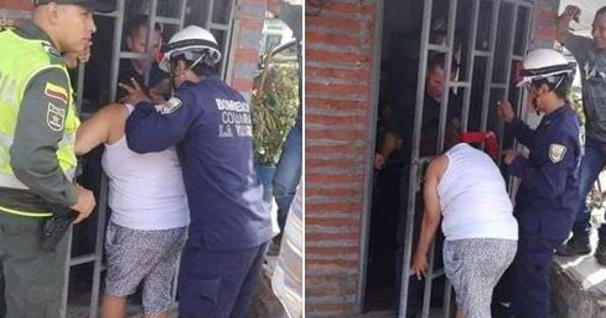 Mulher fica com cabeça presa em portão após tentar espiar casa da vizinha
