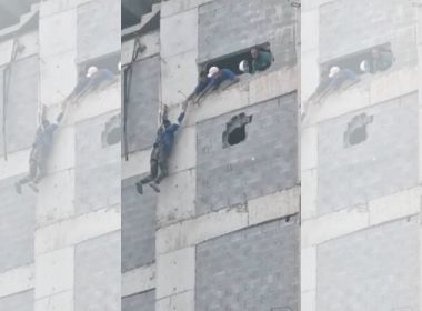 Funcionário fica pendurado no alto de prédio em Guarujá