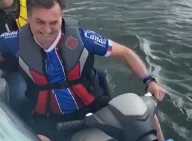 Após citar demissões em fábrica, Bolsonaro passeia de moto aquática com camisa do Bahia